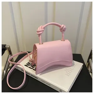 Pink top handle shoulder bag with unique curved bottom design, stylish women handbag.
