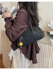 Detailed view of women's vintage black shoulder pillow bag, stylish retro daily commuter purse.