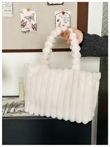 Close-up of winter white fluffy plush tote bag with cute bubble handles, cozy style.