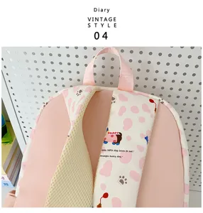 Pink canvas school backpack detail view, cute dog pattern strap, breathable mesh design.