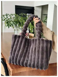 Pluffy plush tote bag detail view, soft autumn winter fluffy handbag with round handle.