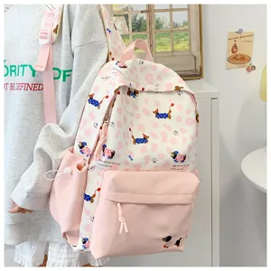 Close-up detail of the cute pink and white dog print ins style school backpack for girls.