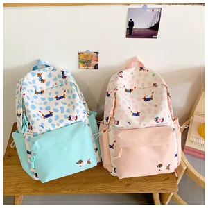 Cute student backpack set in blue and pink with playful dog print for daily school use.
