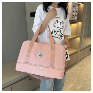 Pink quilted travel duffel bag with large capacity, wet-dry separation, and shoulder strap for fitness.