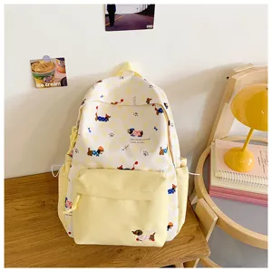 Detail shot of the cute yellow dog print backpack with front pocket and side pockets.