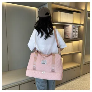 Pink quilted travel duffel bag with bottom compartment, large capacity gym bag for women.