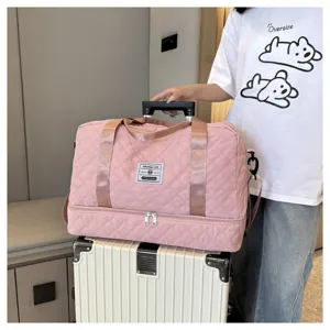 Pink quilted travel duffel bag with dry wet separation compartment for fitness gym use.