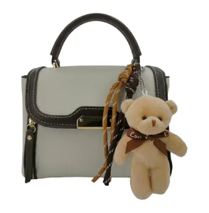 Women stylish colorblock shoulder bag with cute bear pendant and top handle design.