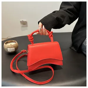 Red leather shoulder bag, trendy curved design handbag for women commuting and daily fashion use.