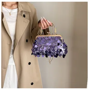 Stylish purple sequin handbag with gold metal frame and chic chain strap for daily wear.
