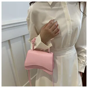 Pink stylish shoulder handbag for women, elegant curved flap design, perfect for daily commuting.