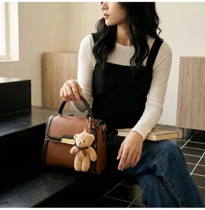 Chic brown contrast color shoulder bag for women, stylish minimalist handbag with cute bear charm.