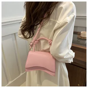 Pink minimalist asymmetrical crossbody shoulder bag detail, stylish commute women handbag.