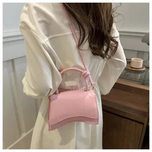 Pink leather women's shoulder bag, stylish handbag detail showcasing minimalist design.