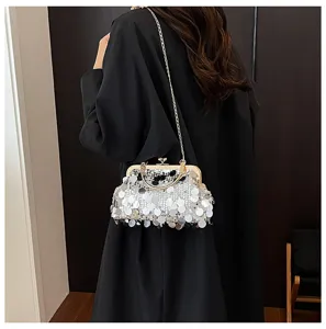 Detailed view of fashionable sequined shoulder chain bag featuring elegant gold metal frame.