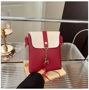Red and white color block mini phone bag detail, cute deer pendant, stylish crossbody design.