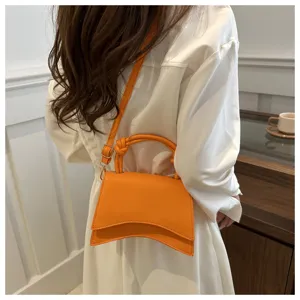 Orange shoulder handbag for women, chic casual stylish crossbody bag with curved base.