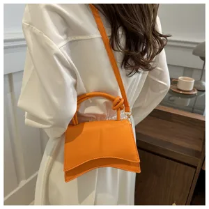 Orange stylish women shoulder crossbody bag, modern curved design handbag for commute.