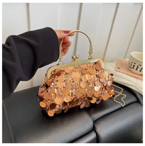 Detailed view of the sparkling sequin evening clutch bag featuring a gold frame and chain strap.