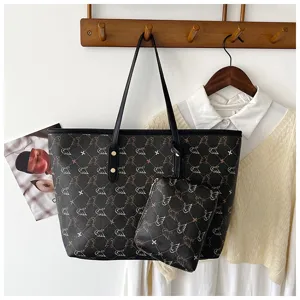 Detail view of the retro dark brown tote bag featuring elegant bird monogram pattern and pouch.