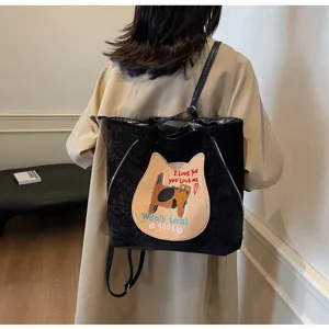 Detailed view of black velvet tote backpack showcasing cute cat patch and letter embroidery.