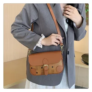 Stylish brown crossbody bag for women, classic monogram design with adjustable strap.