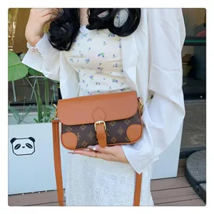 Chic vintage monogram shoulder bag detail, stylish crossbody small square bag for women.