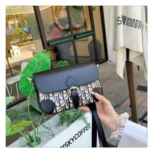 Detailed view of the stylish chic monogram shoulder bag with metallic buckle and strap.