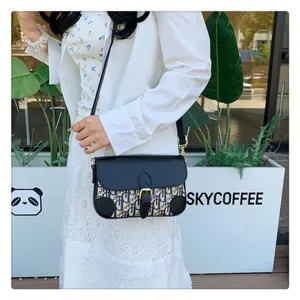 Detailed shot of a stylish monogram shoulder crossbody bag with elegant flap and metal buckle.