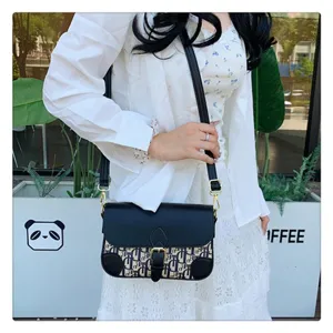 Chic shoulder crossbody bag with classic monogram canvas and sleek black flap design.