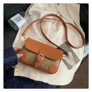 Detailed view of the stylish brown monogram crossbody bag with retro buckle and strap.