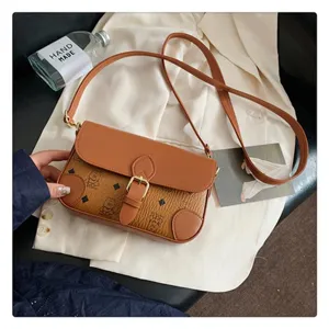 Detail view of the retro brown monogram crossbody bag, featuring classic pattern and metal buckle.