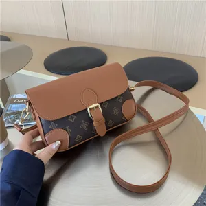 Brown retro monogram shoulder bag for women, stylish crossbody bag with flap and buckle.