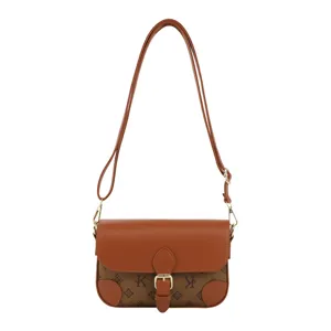 Stylish brown monogram crossbody bag with flap and buckle, chic shoulder bag for women.