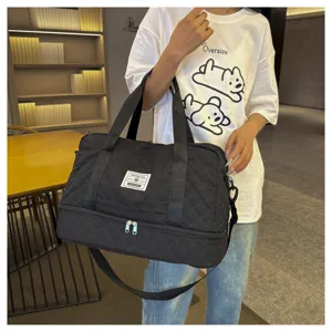 Large capacity black quilted travel duffel bag with shoe compartment for gym sports.