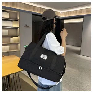Black quilted travel duffel bag with bottom compartment, gym fitness shoulder bag detail.