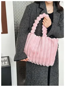 Pink fluffy plush tote bag for women, cozy winter furry handbag with cute ball handle.