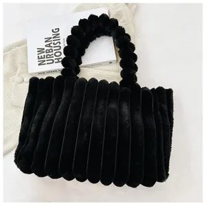 Chic black plush tote bag, fluffy winter handbag with stylish round handle and cozy texture.