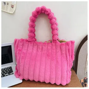 Stylish pink fuzzy tote bag with cute pom-pom handles, cozy winter plush shoulder bag.
