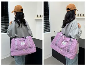 Large capacity quilted travel duffel bag with wet dry separation and shoulder strap for gym.