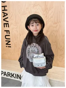 Kids silver bow crossbody bag detail view, trendy metallic purse for little girls.