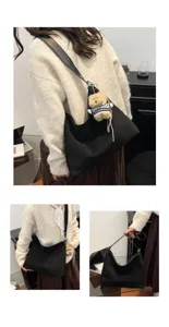 Black minimalist hobo shoulder bag for women, slouchy large capacity tote with cute bear charm.