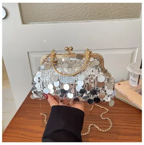 Sparkling silver sequin clutch bag detail showing delicate kiss-lock metal frame and chain.
