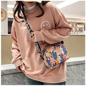 Women's cute cartoon print crossbody bag with fashion letter strap, casual daily shoulder bag.
