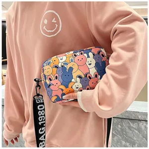 Close-up detail of stylish cute cartoon rabbit printed women crossbody shoulder bag detail shot.