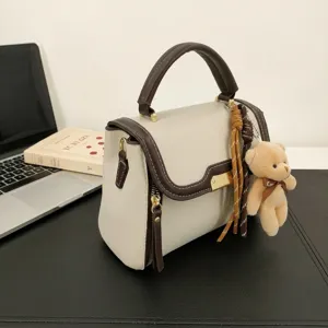 Chic colorblock top-handle shoulder bag with cute bear pendant for women daily use