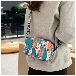 Detail view of the cute cartoon rabbit print crossbody bag with durable woven shoulder strap.