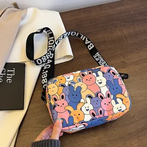 Cute cartoon rabbit print crossbody bag with stylish letter strap for daily casual wear.