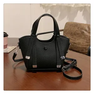 Black PU leather tote bag detail, featuring textured finish and sturdy metal hardware accents.