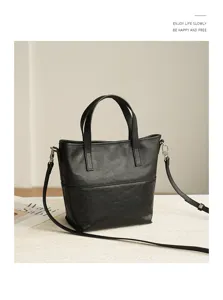 Minimalist black leather tote bag detail view, casual retro large capacity shoulder bag for women.